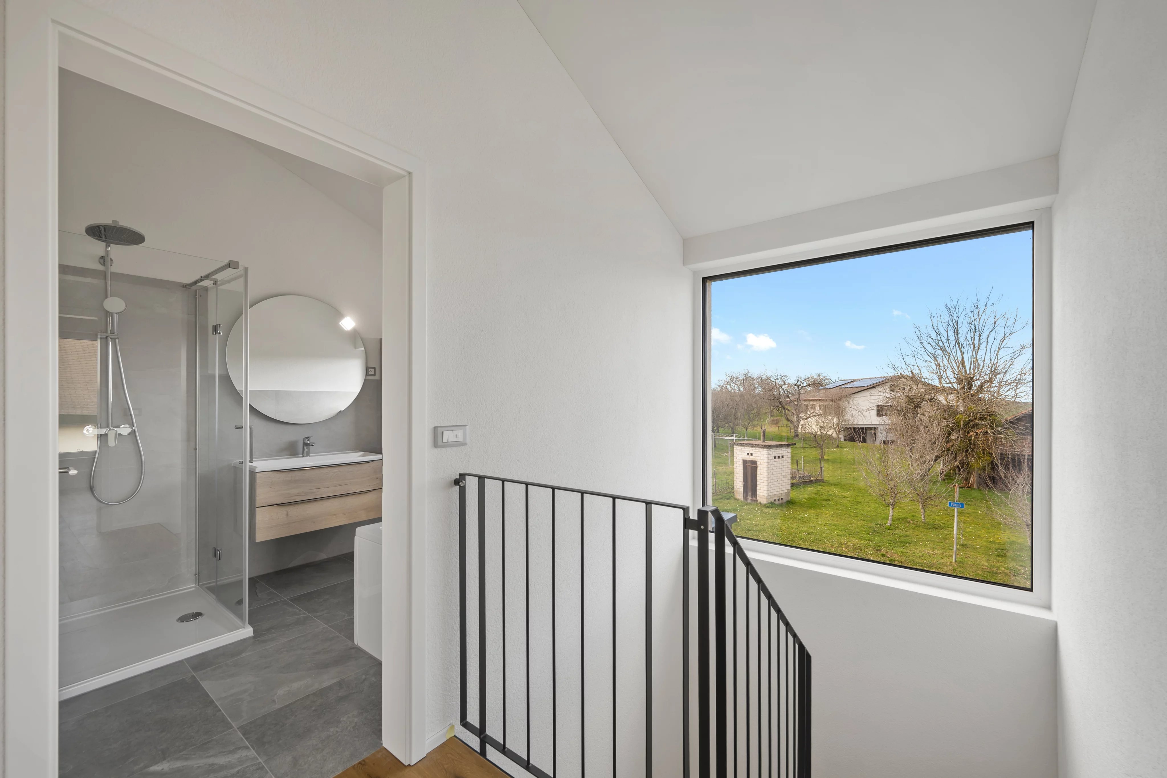 Modernes Treppenpodest mit Bad- und Gartenblick