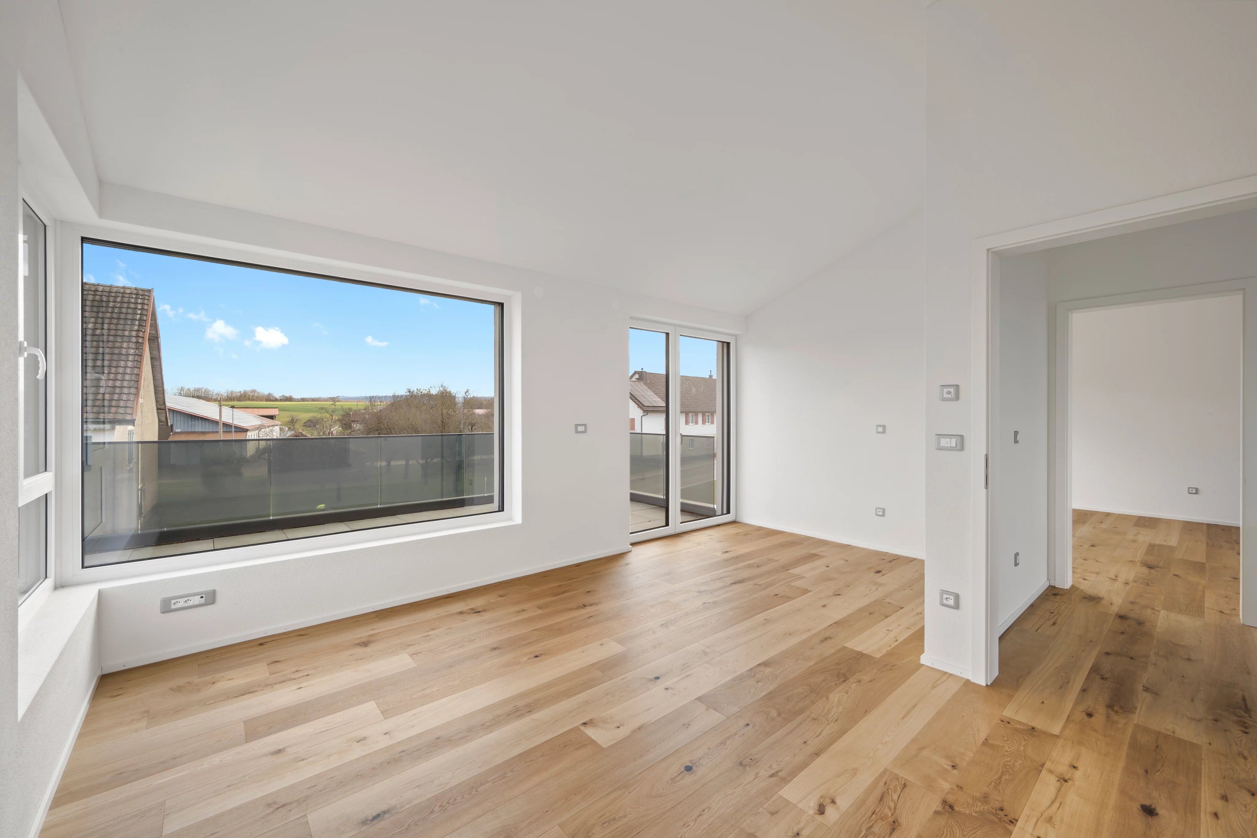 Heller leerer Wohnraum mit Balkon und Weitblick