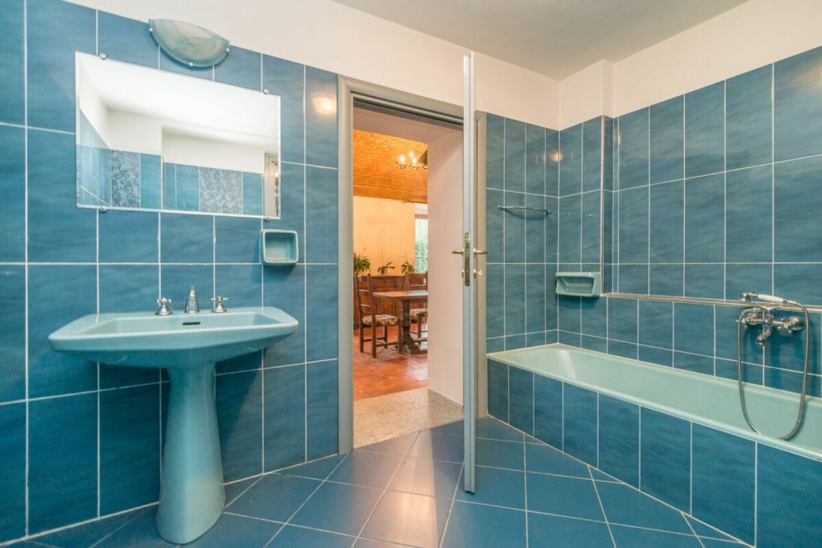 Badezimmer mit türkisfarbenen Fliesen und Badewanne