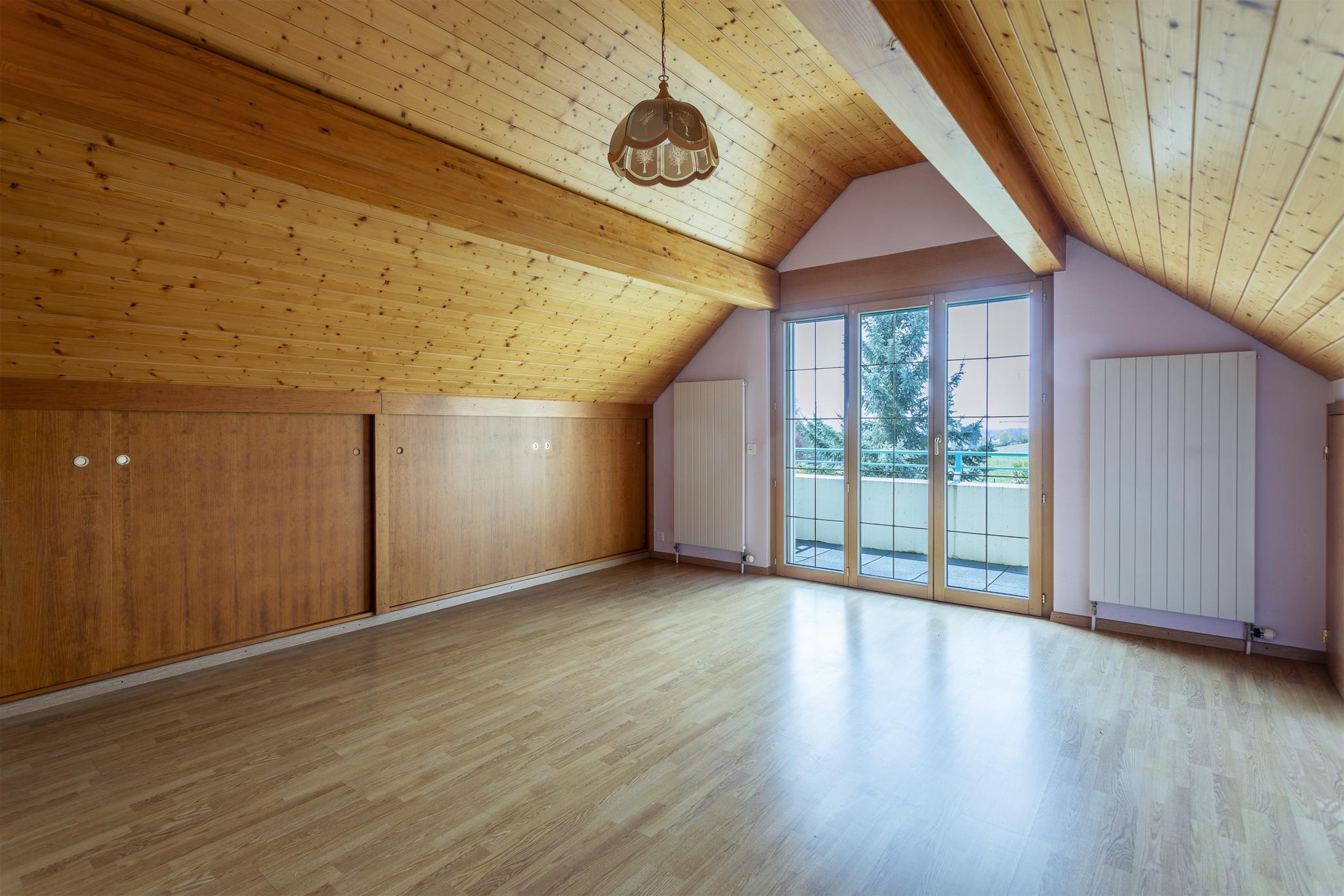 Dachgeschosszimmer mit Balkonzugang