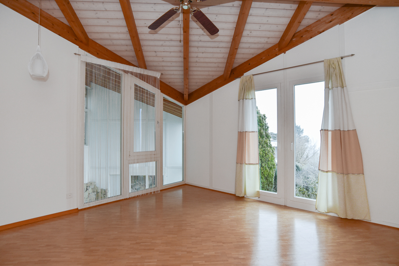 Lichtes Zimmer mit sichtbaren Holzbalken