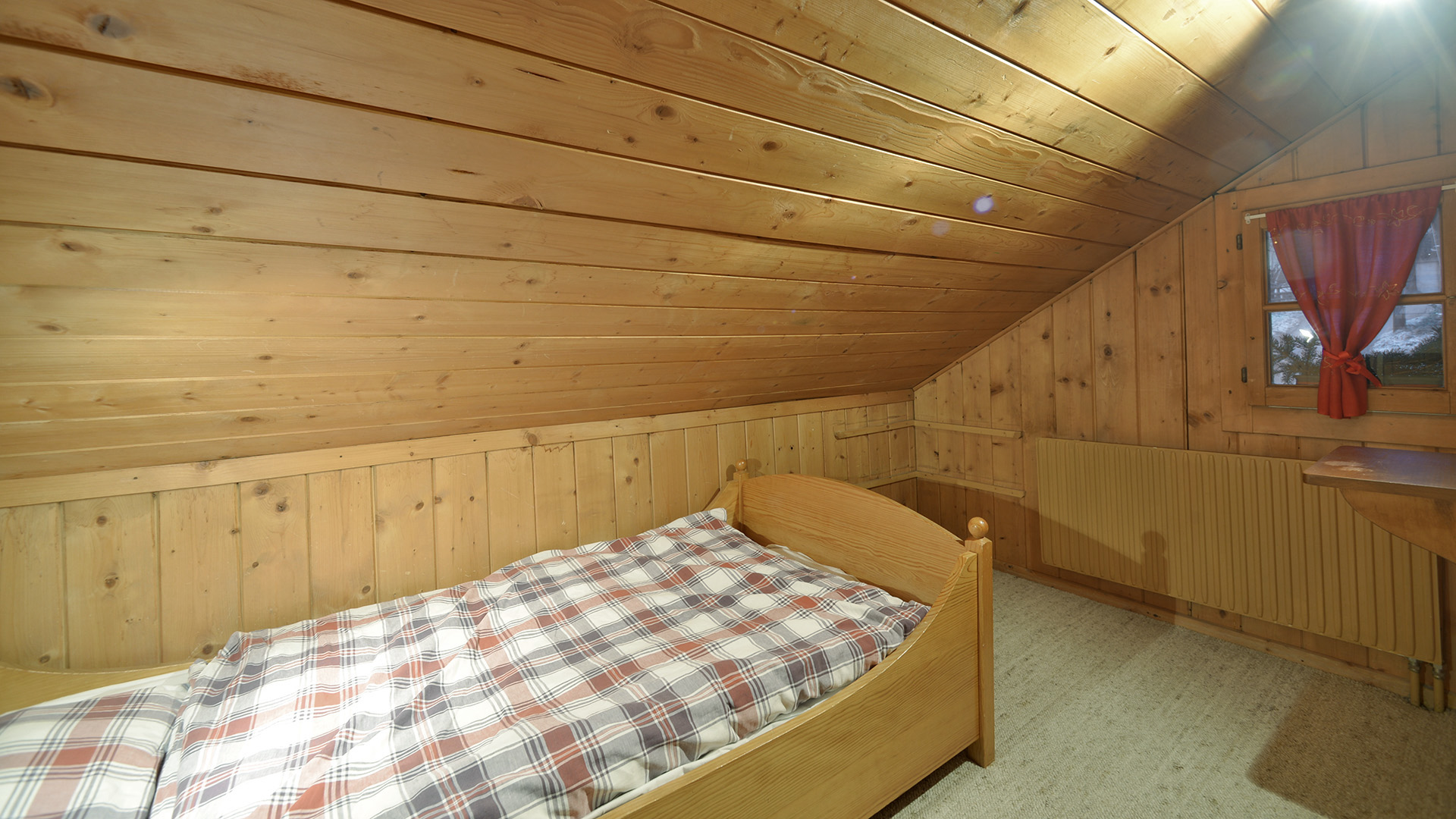Gemütliches Holzzimmer mit Bett