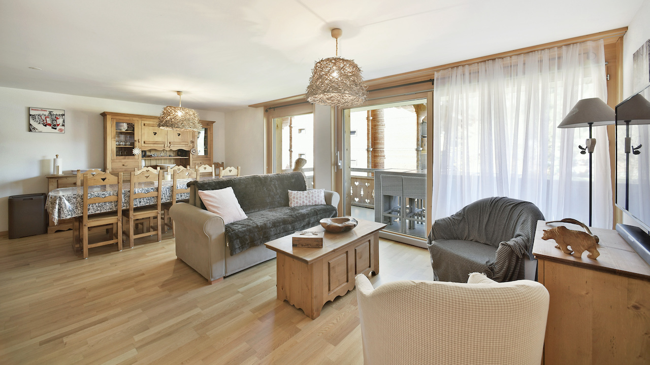 Helles Wohnzimmer mit Essbereich und Balkonblick