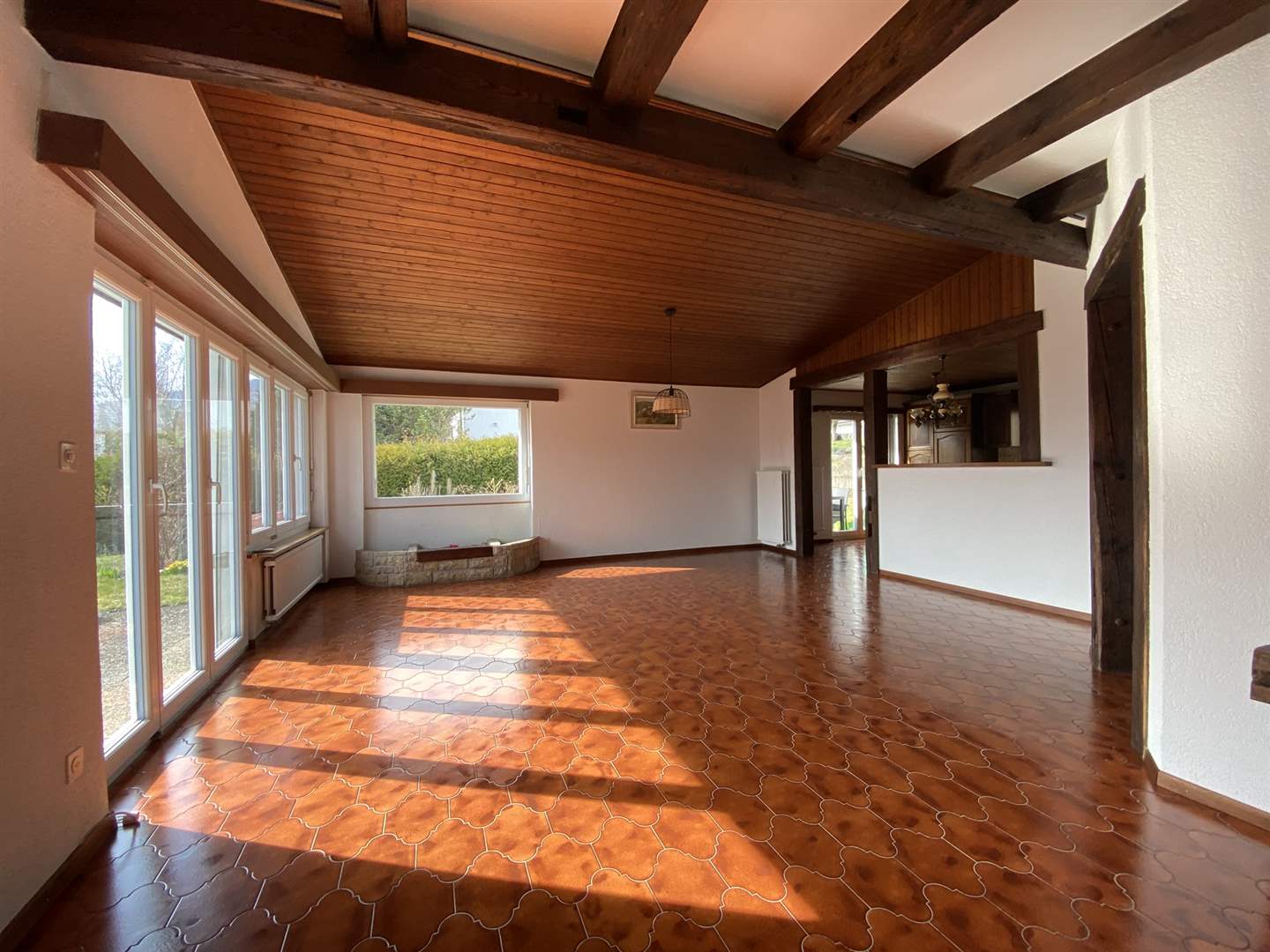Heller Wohnraum mit Holzdecke und Fliesenboden