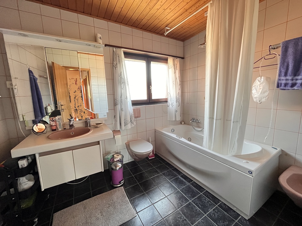 Badezimmer mit Wanne und Waschtisch