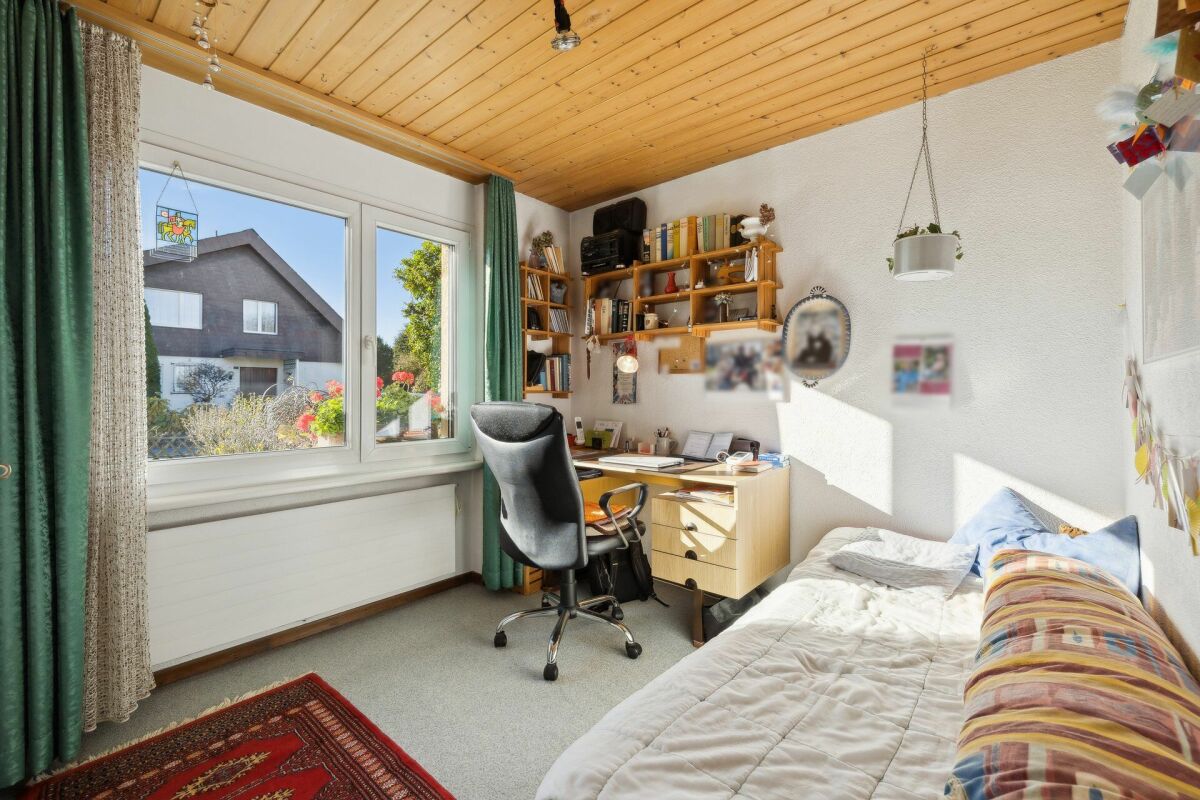 Kleines Schlafzimmer mit Arbeitsbereich am Fenster