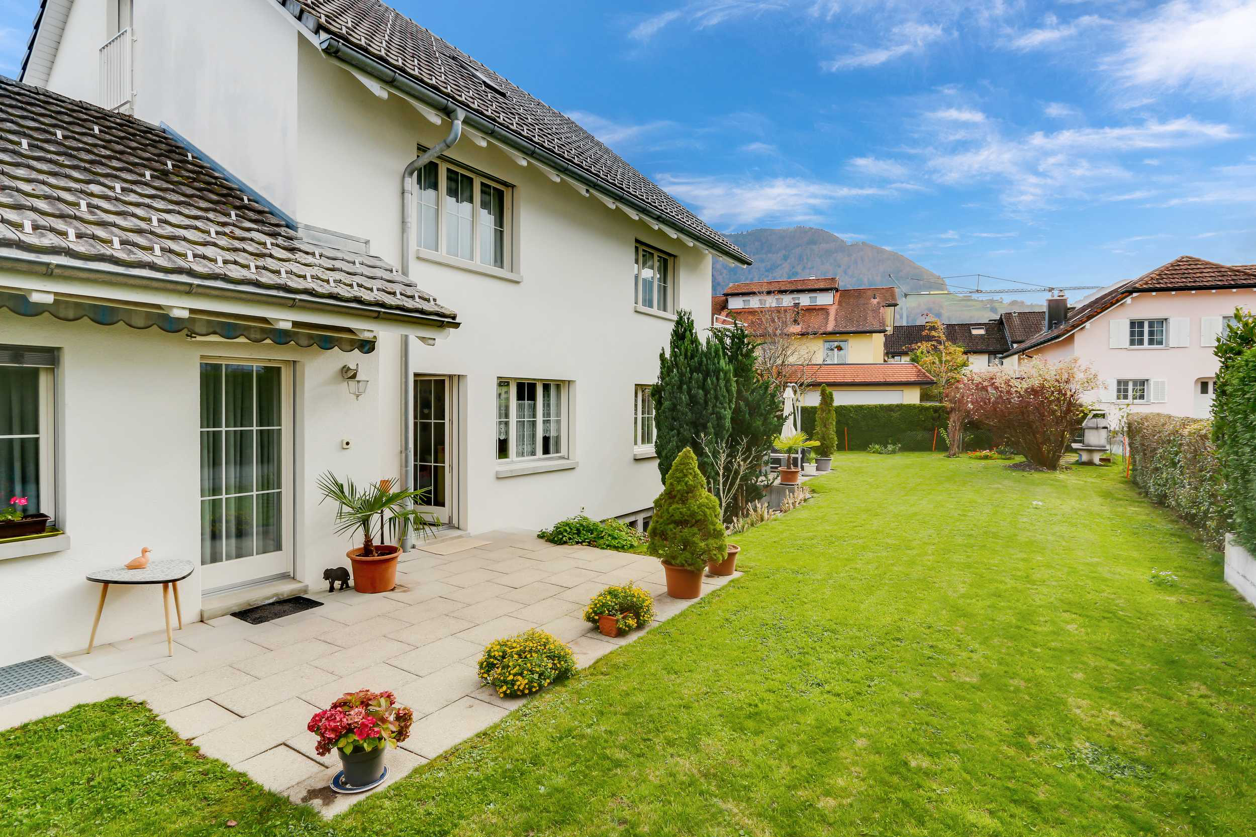 Gepflegter Garten mit Einfamilienhaus und Terrasse