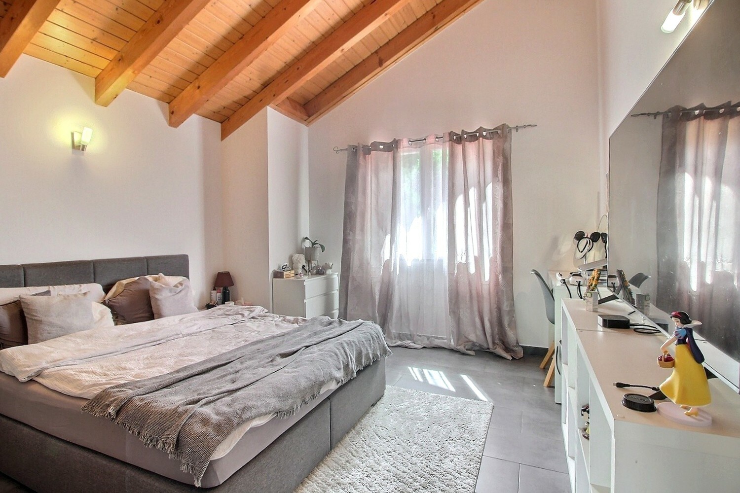 Helles Schlafzimmer mit sichtbaren Holzbalken