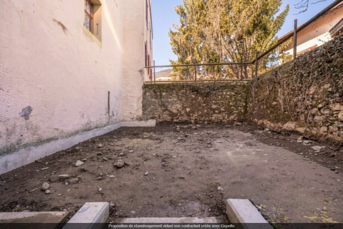 Unbefestigter Innenhof mit Steinmauern
