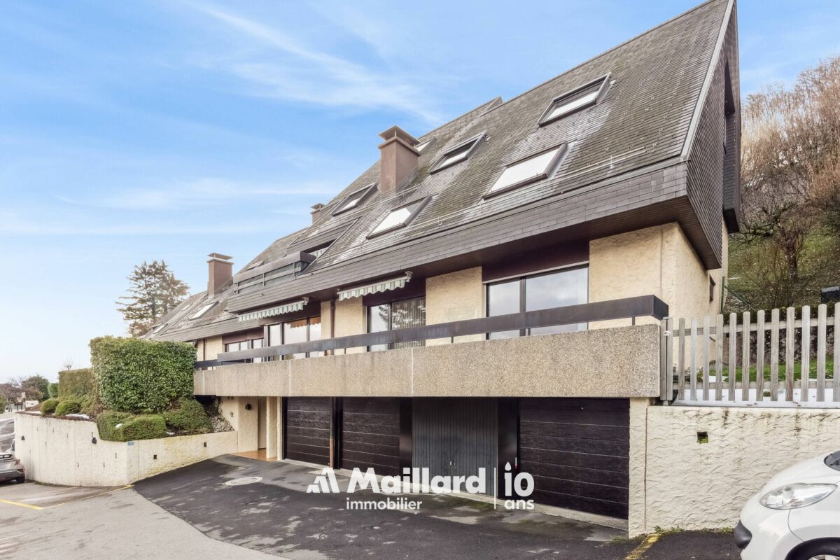 Mehrfamilienhaus mit steilem Schrägdach und Garagenfront