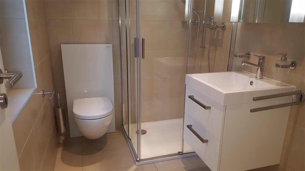 Modernes Badezimmer mit WC und Glasdusche