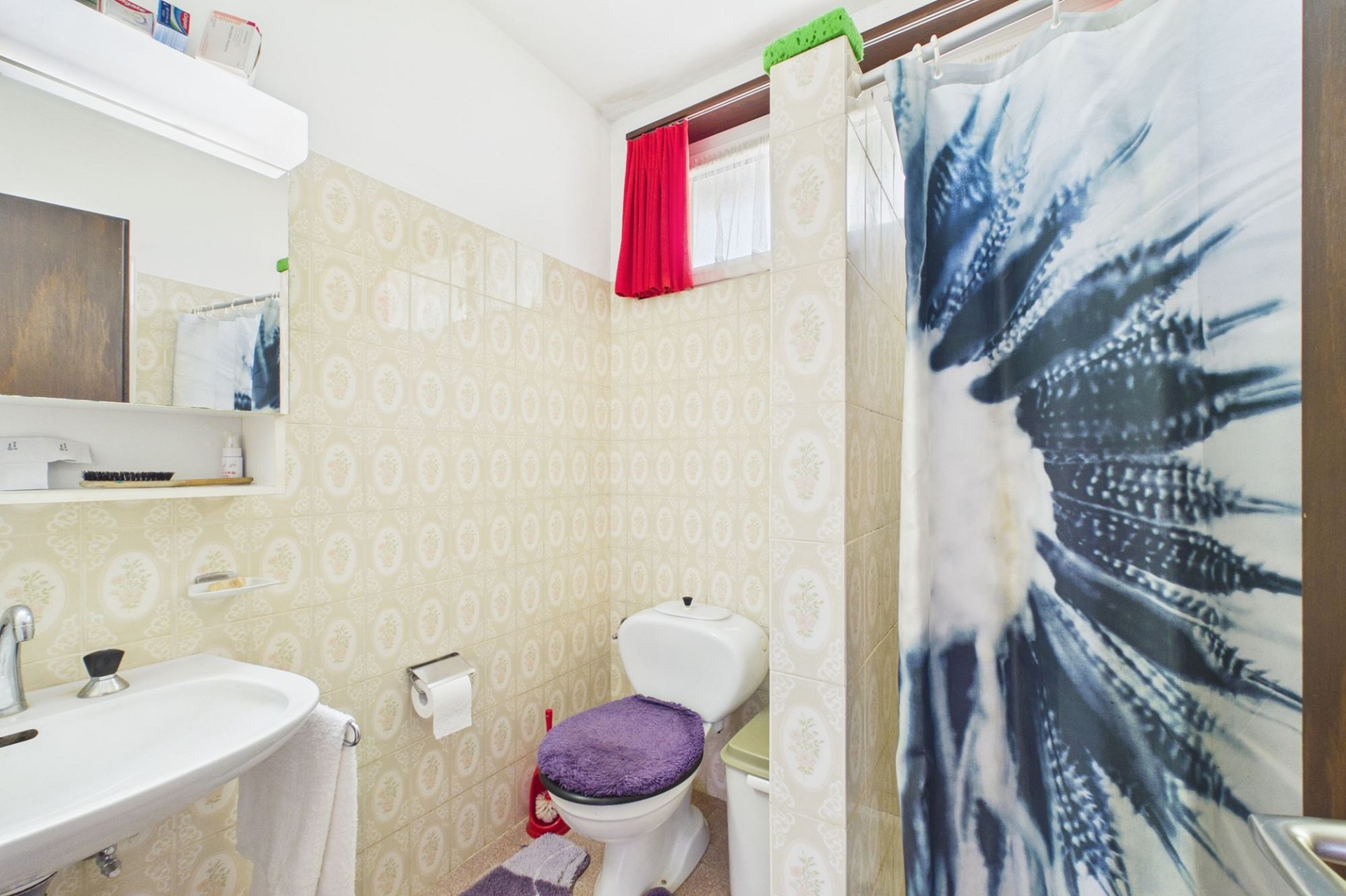 Kleines Badezimmer mit WC und Duschvorhang