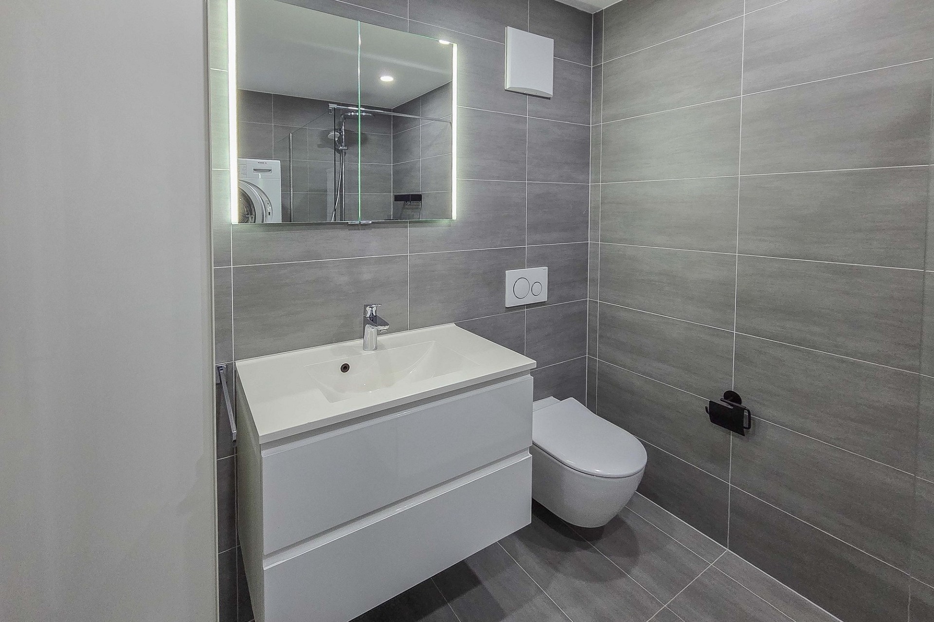 Modernes Badezimmer mit grauen Fliesen