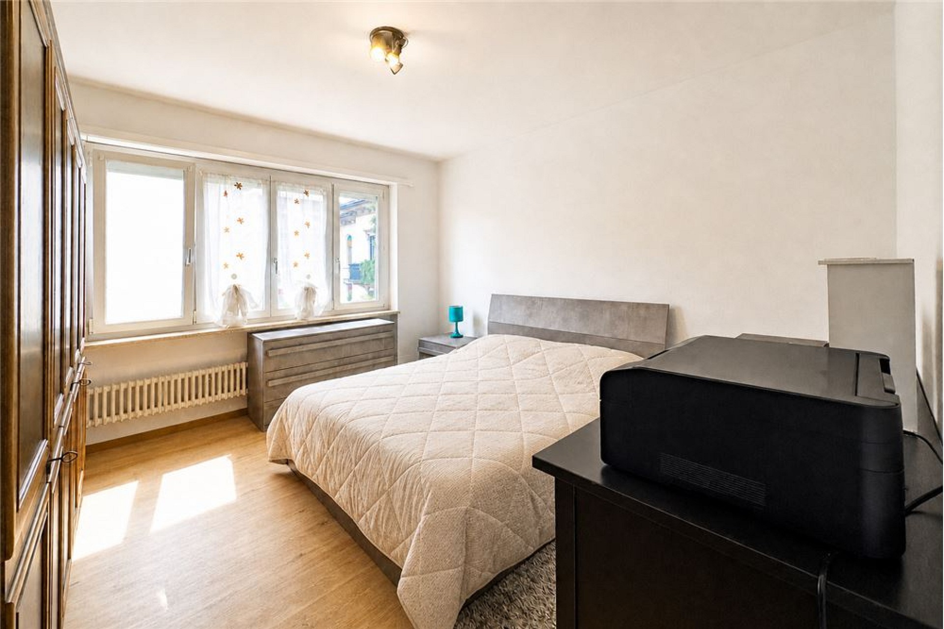 Helles Schlafzimmer mit Bett und Fensterfront