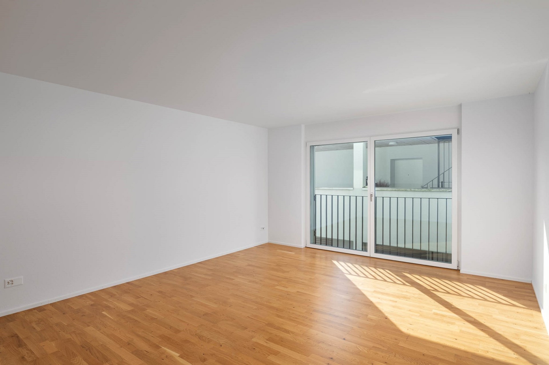 Heller leerer Wohnraum mit Balkonblick