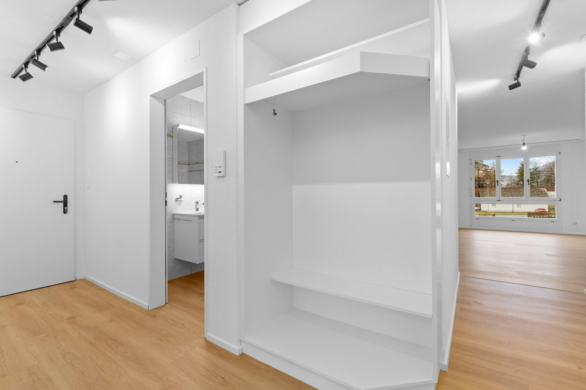 Heller Flur mit Blick in Wohnraum und Bad