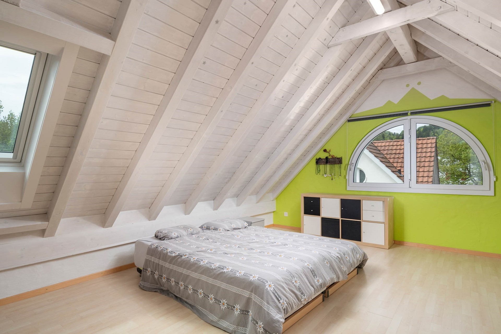 Dachgeschoss-Schlafzimmer mit sichtbaren Holzbalken