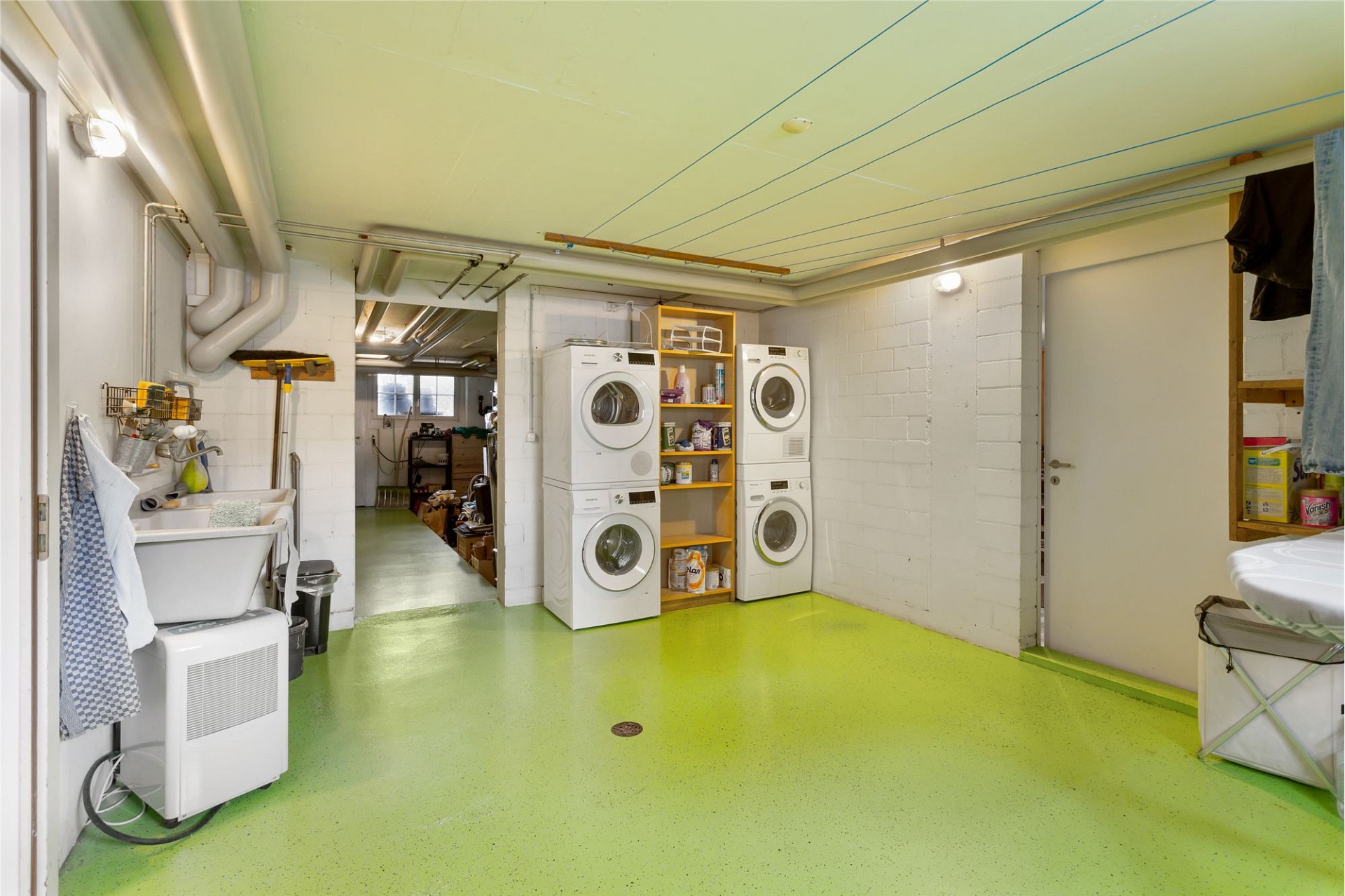 Hauswirtschaftsraum mit Waschmaschinen und Waschbecken