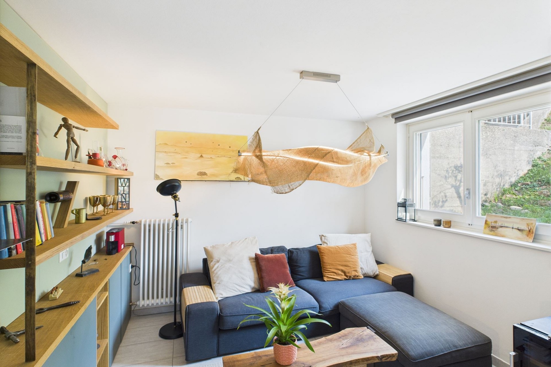 Helles Wohnzimmer mit Sofa und Regalsystem