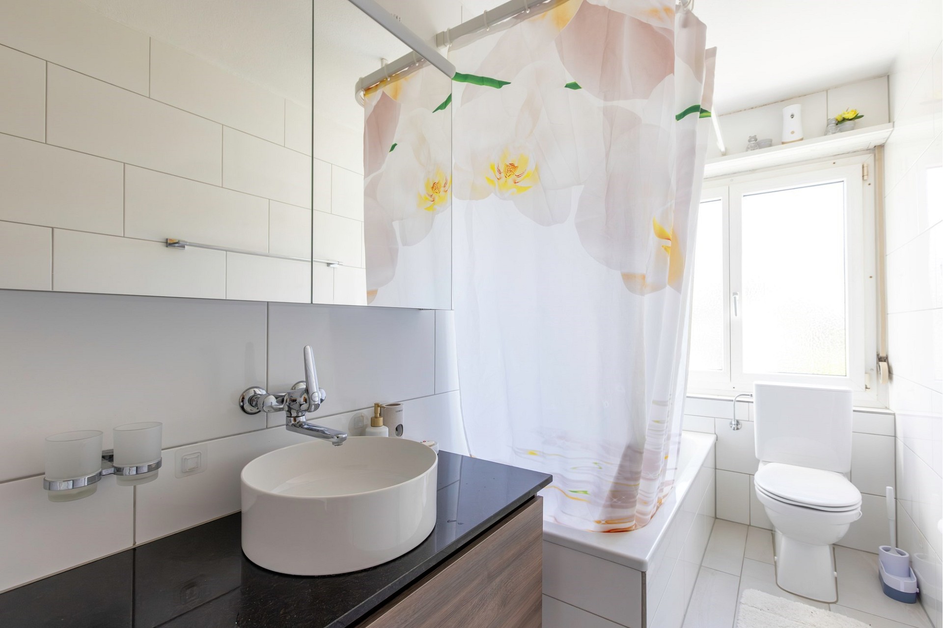 Helles Badezimmer mit Waschbecken, Badewanne und WC
