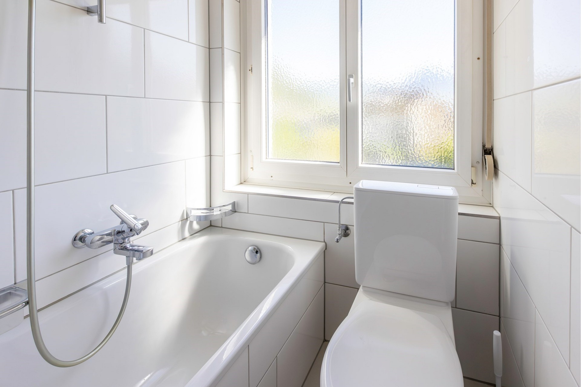 Kleines Badezimmer mit Badewanne und WC