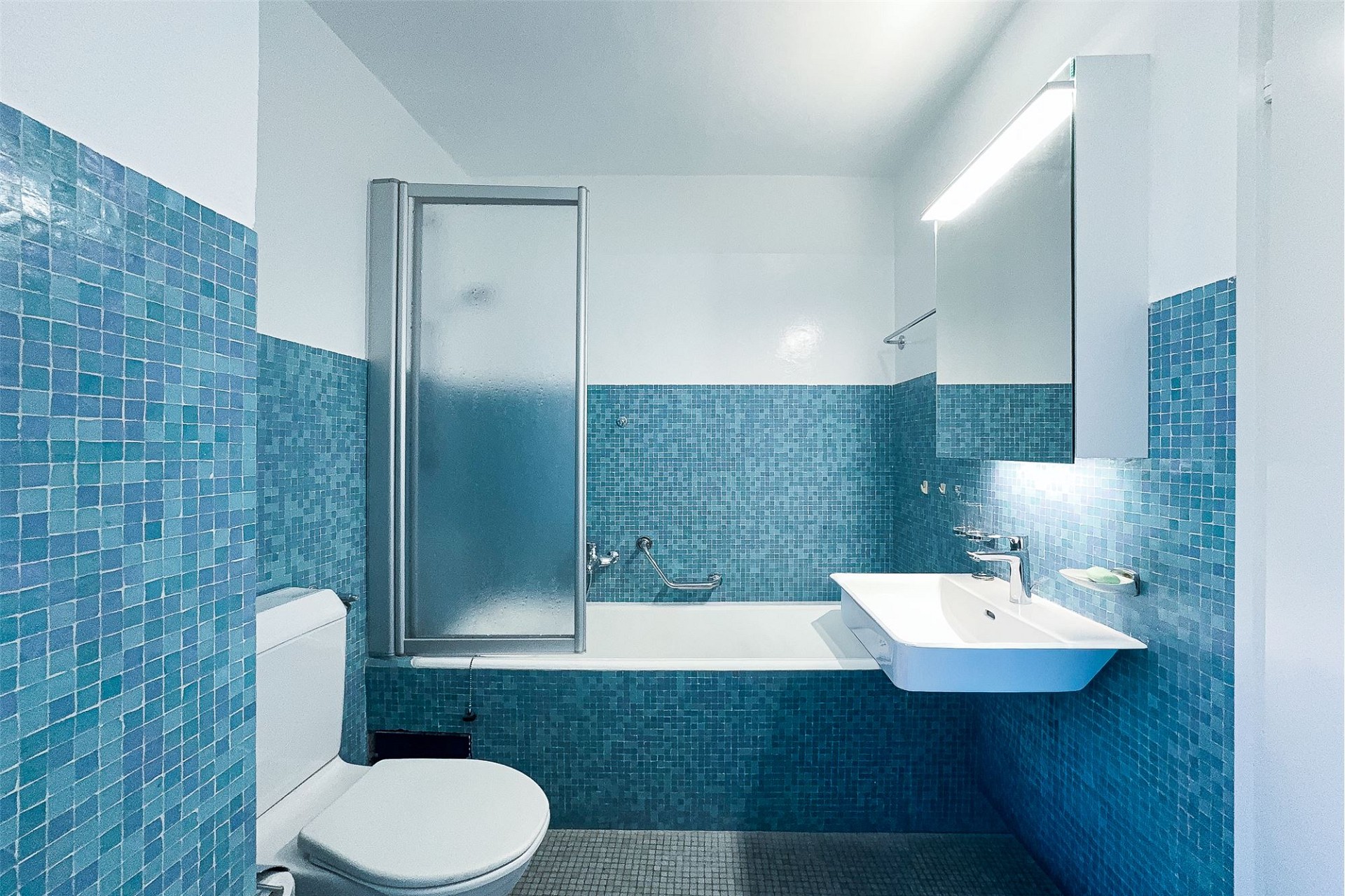 Modernes Badezimmer mit türkisblauen Mosaikfliesen