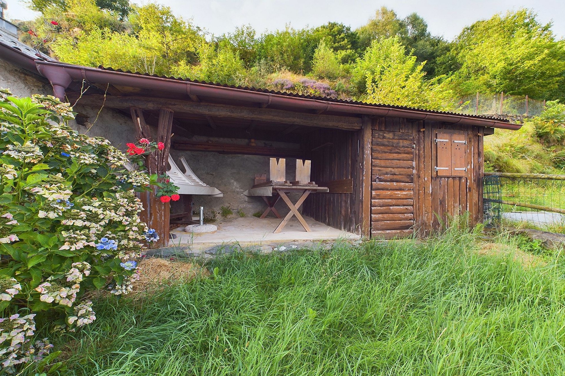 Rustikaler Gartenunterstand mit Holzverkleidung