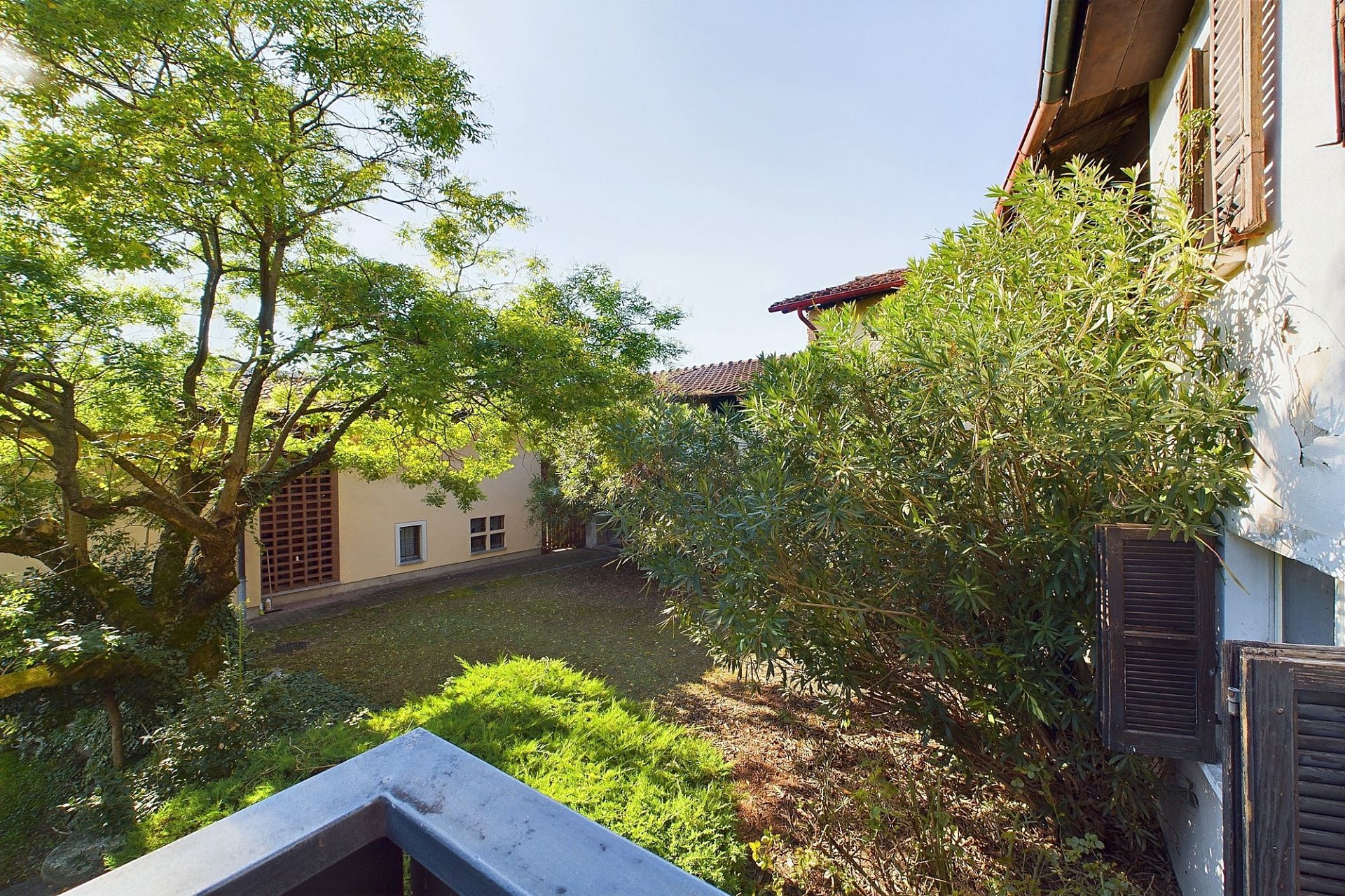 Innenhof mit mediterranem Wohnhaus und viel Grün