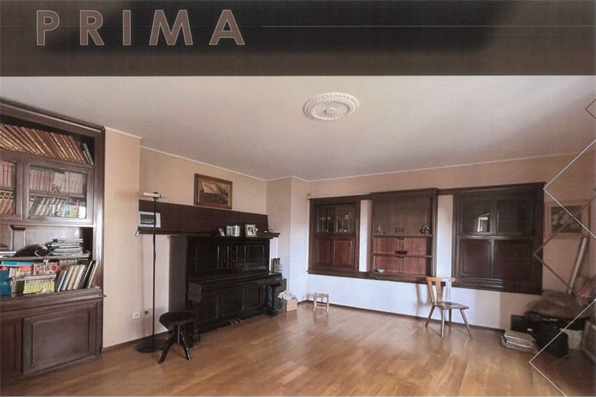 Wohnzimmer mit dunklen Holzvitrinen und Kamin