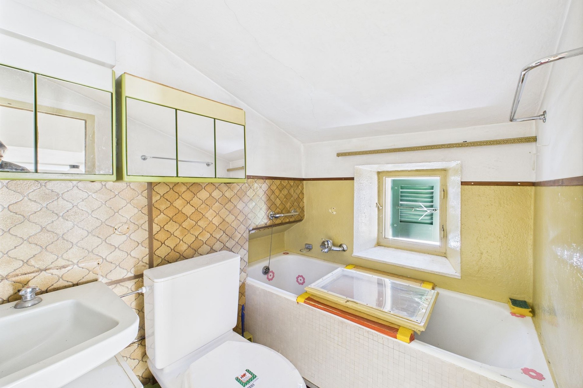 Altmodisches Badezimmer mit Badewanne, Waschbecken und Spiegelschrank