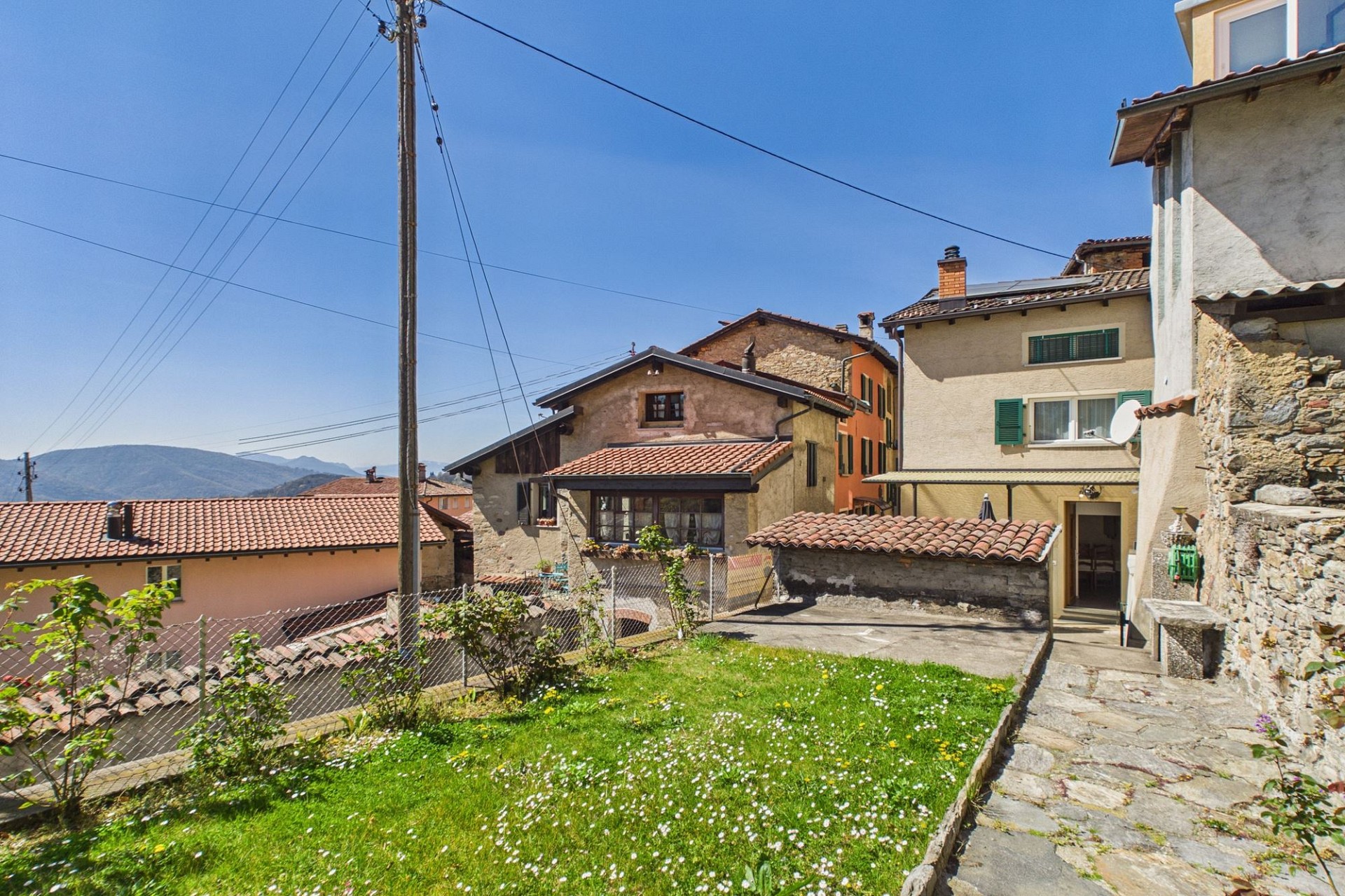 Dorf- bzw. Wohnhaus-Außenansicht mit Garten und Bergblick