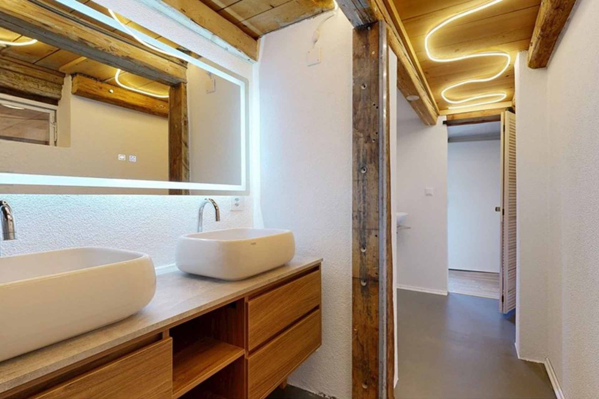 Modernes Bad mit Doppelwaschbecken und Holzdetails