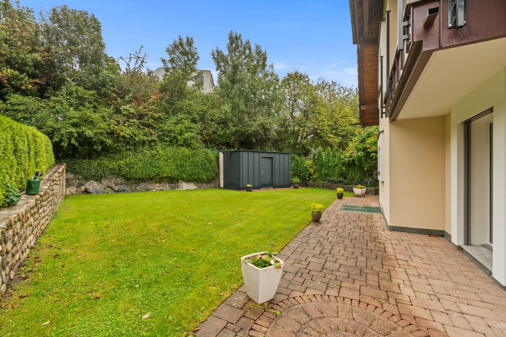 Garten mit Terrasse und Hausansicht