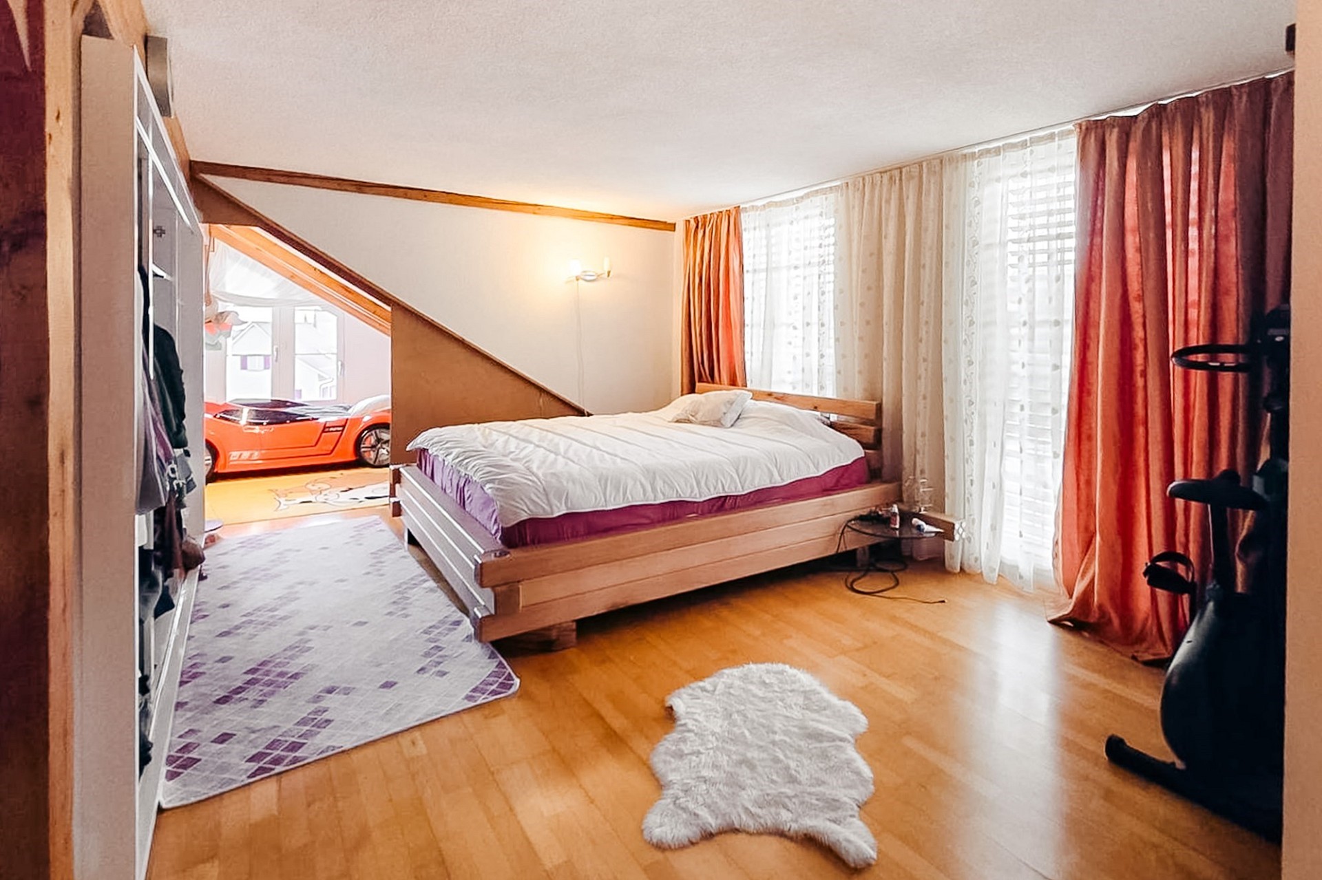 Gemütliches Schlafzimmer mit Dachschräge und Blick in einen Raum darunter