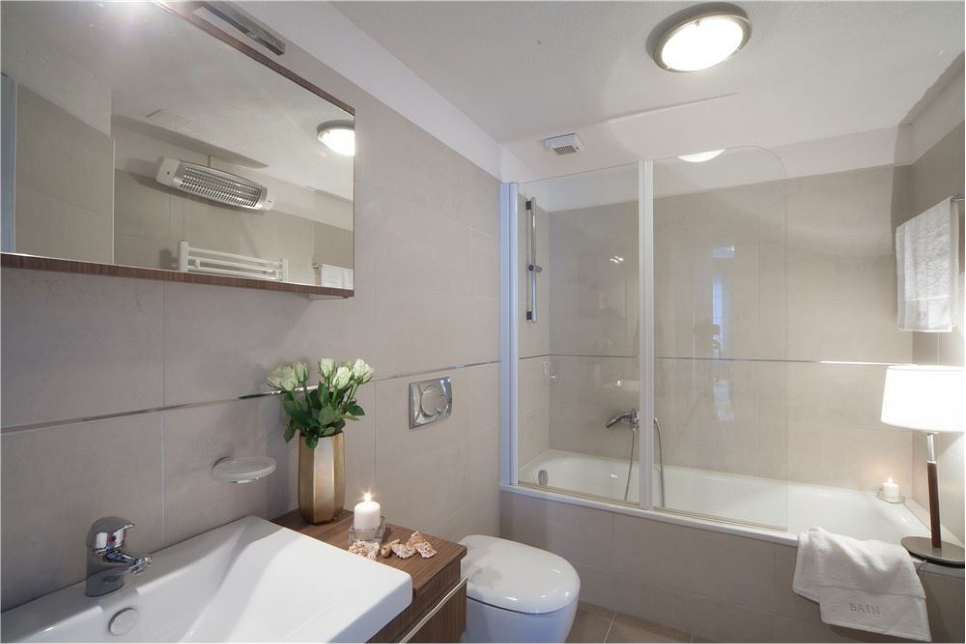 Helles Badezimmer mit Wanne und Glasabtrennung