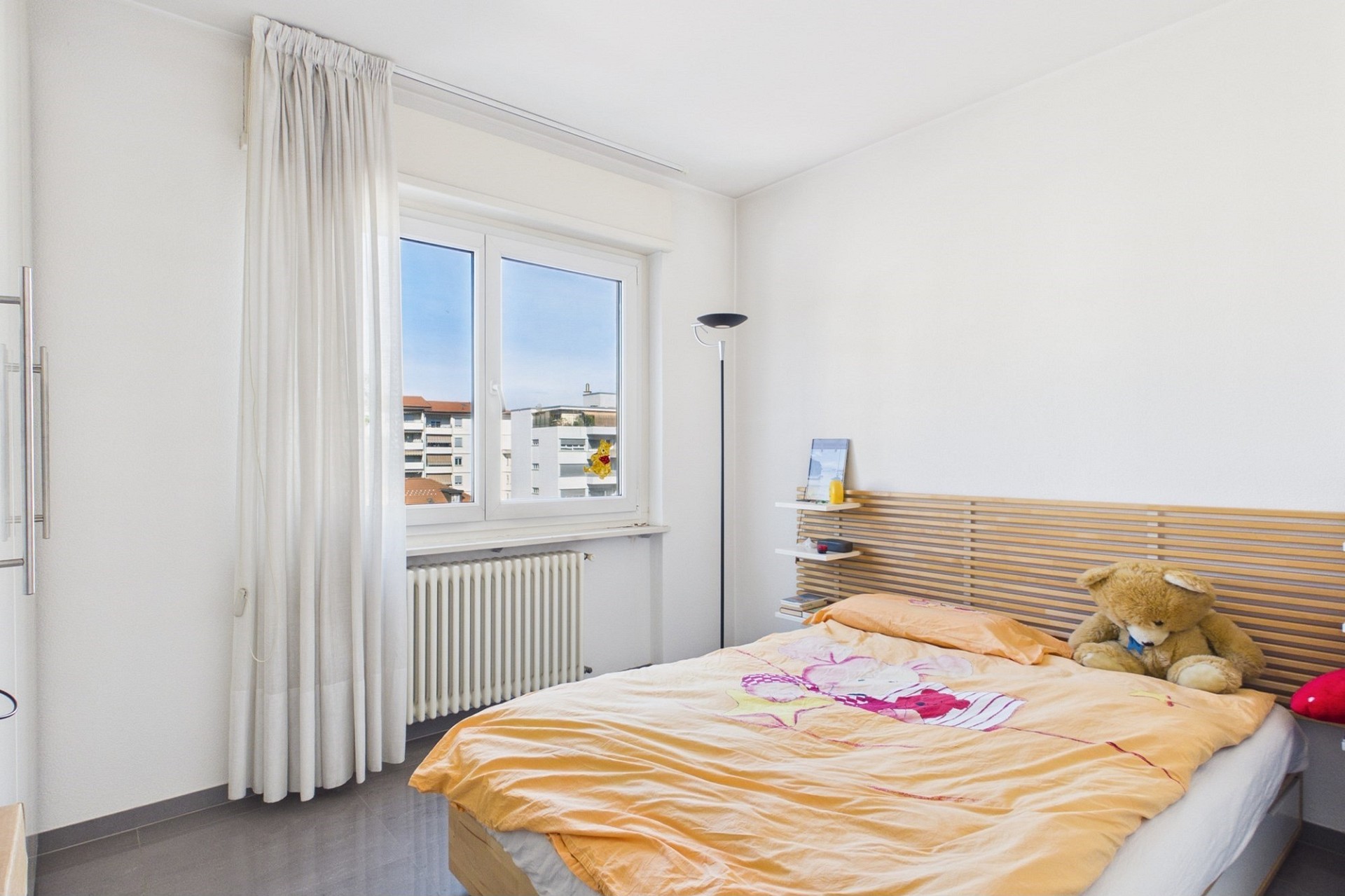 Helles Schlafzimmer mit Fenster und Doppelbett