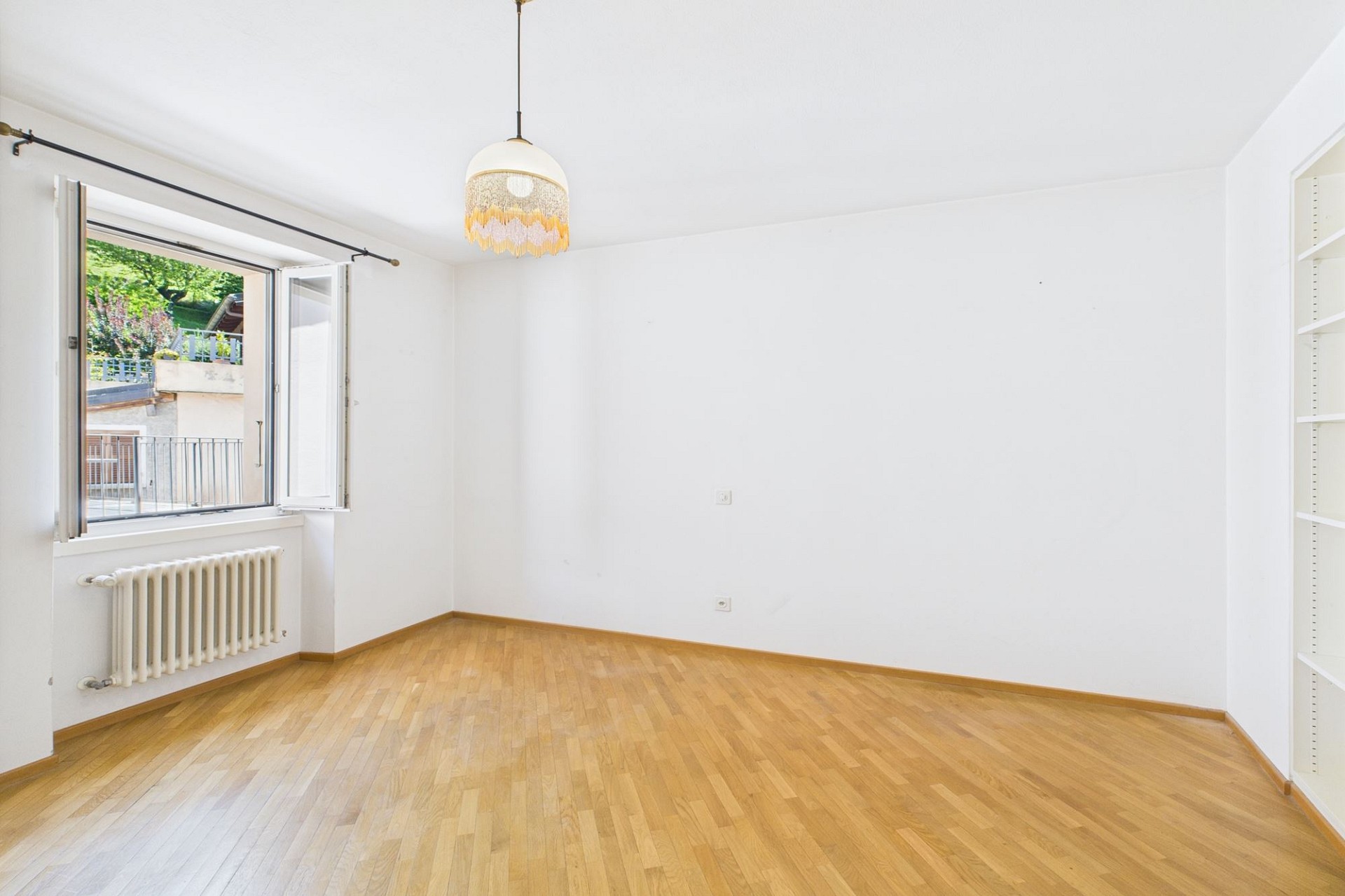 Heller leerer Raum mit Fenster und Holzparkett
