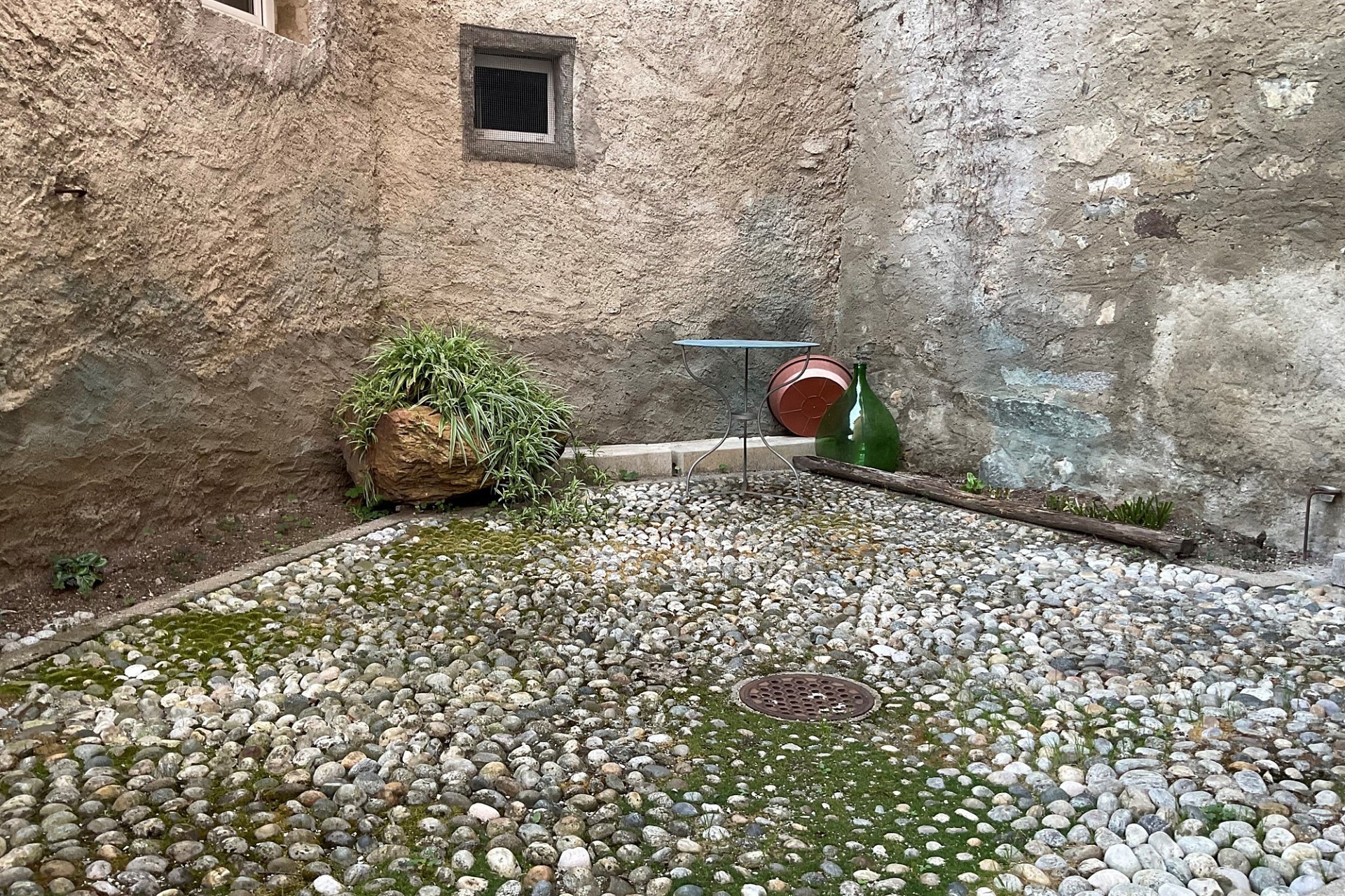 Innenhof mit Natursteinboden und rauen Mauern