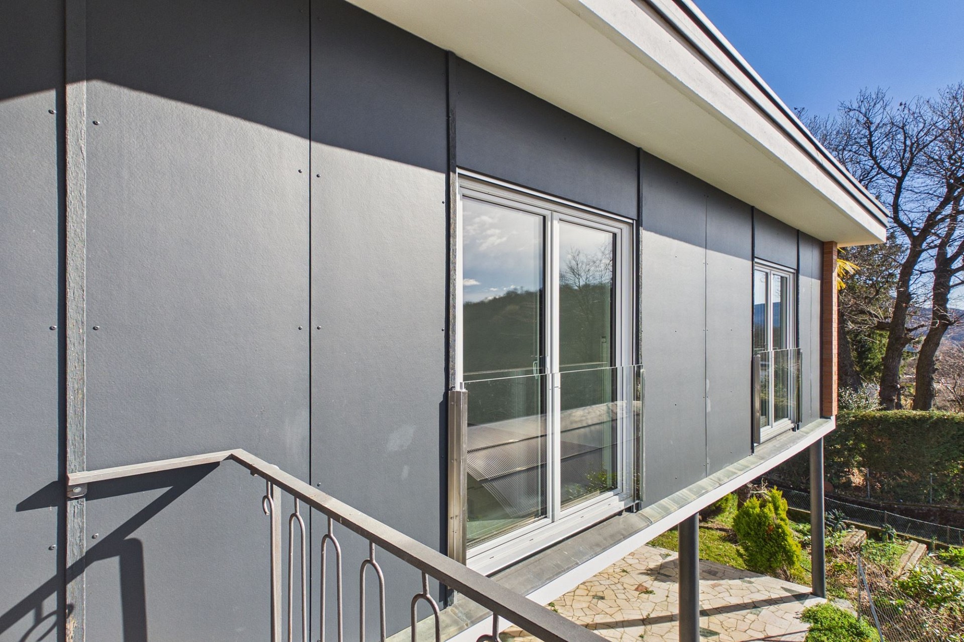 Modernes Gebäude mit Balkon und großen Fenstern