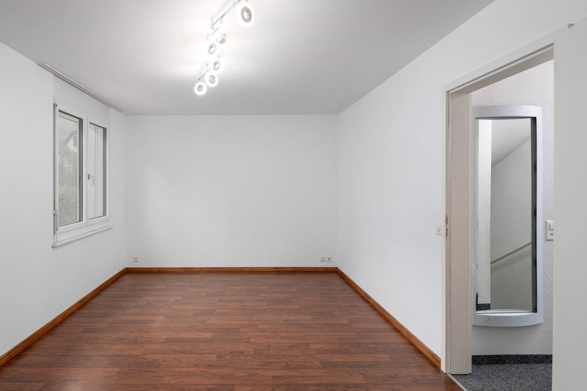 Leerer heller Raum mit Holzfußboden
