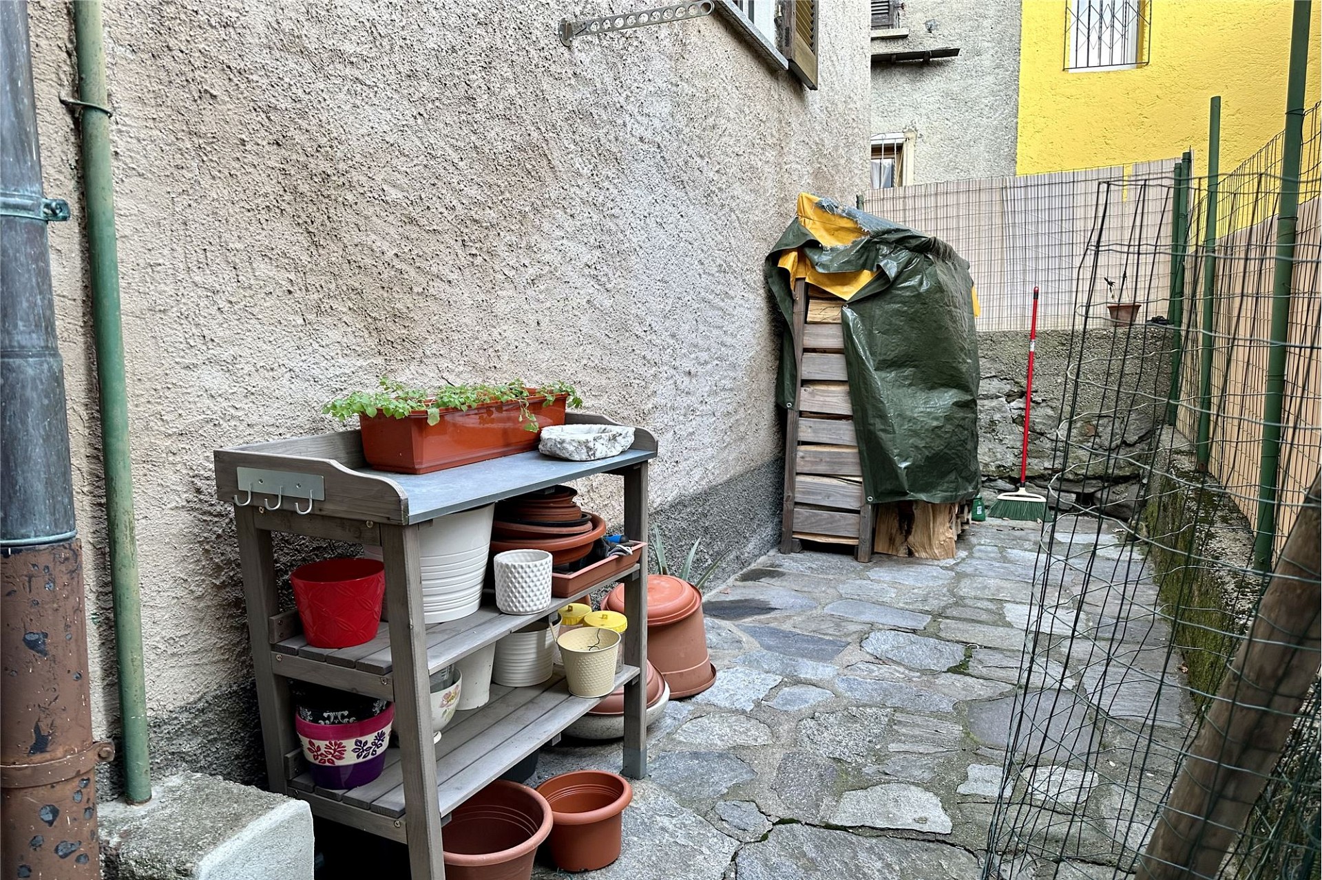 Schmaler Außenhof mit Garten- und Abstellbereich