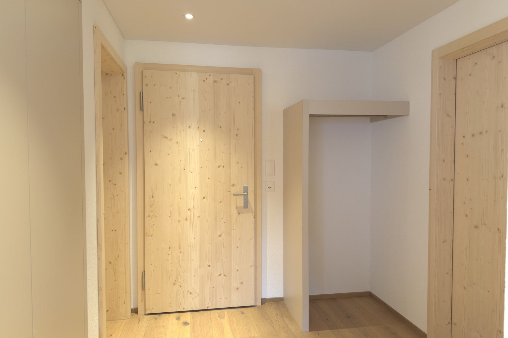 Heller Eingangsbereich mit Holztüren
