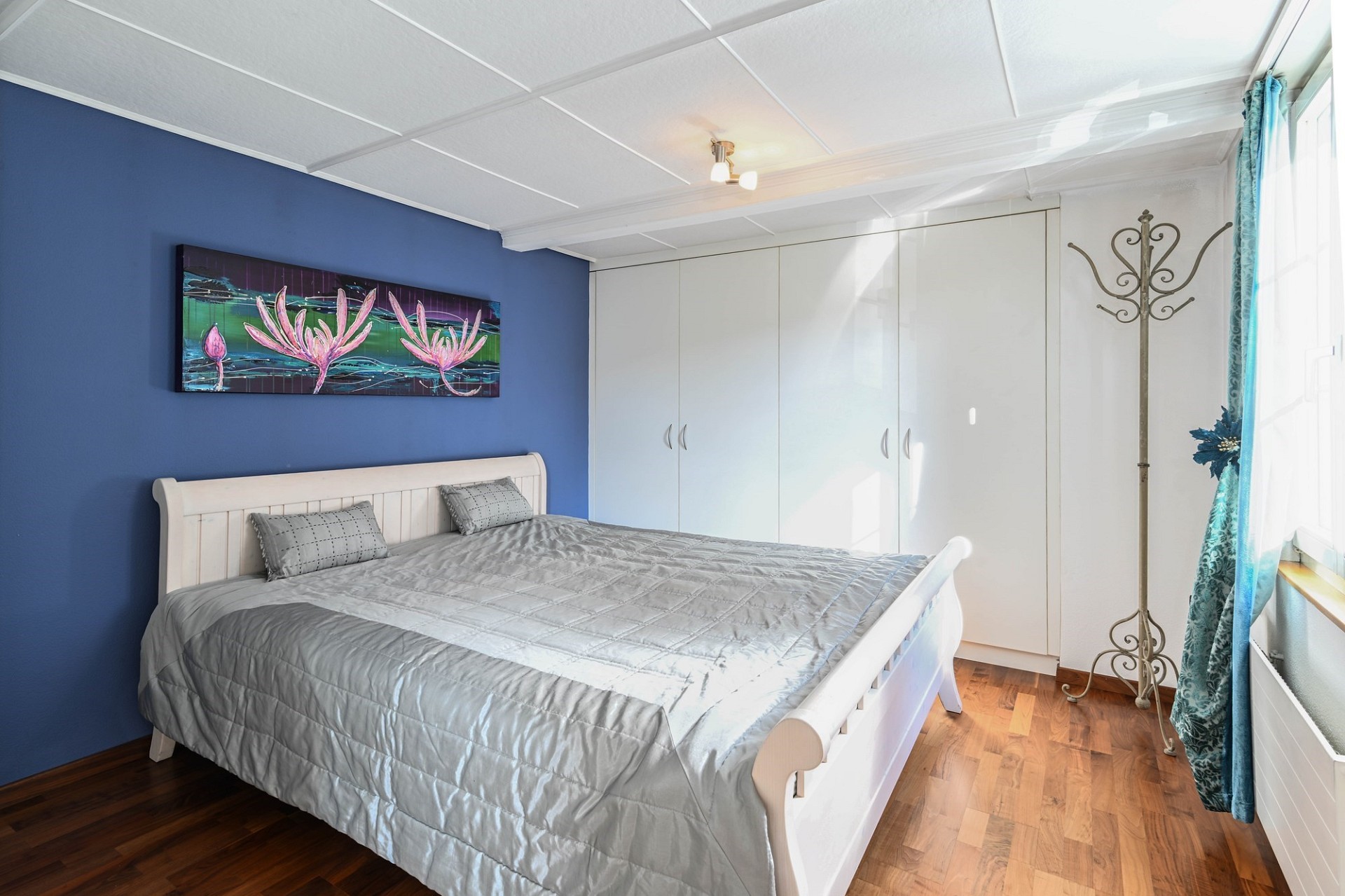 Helles Schlafzimmer mit blauem Akzent