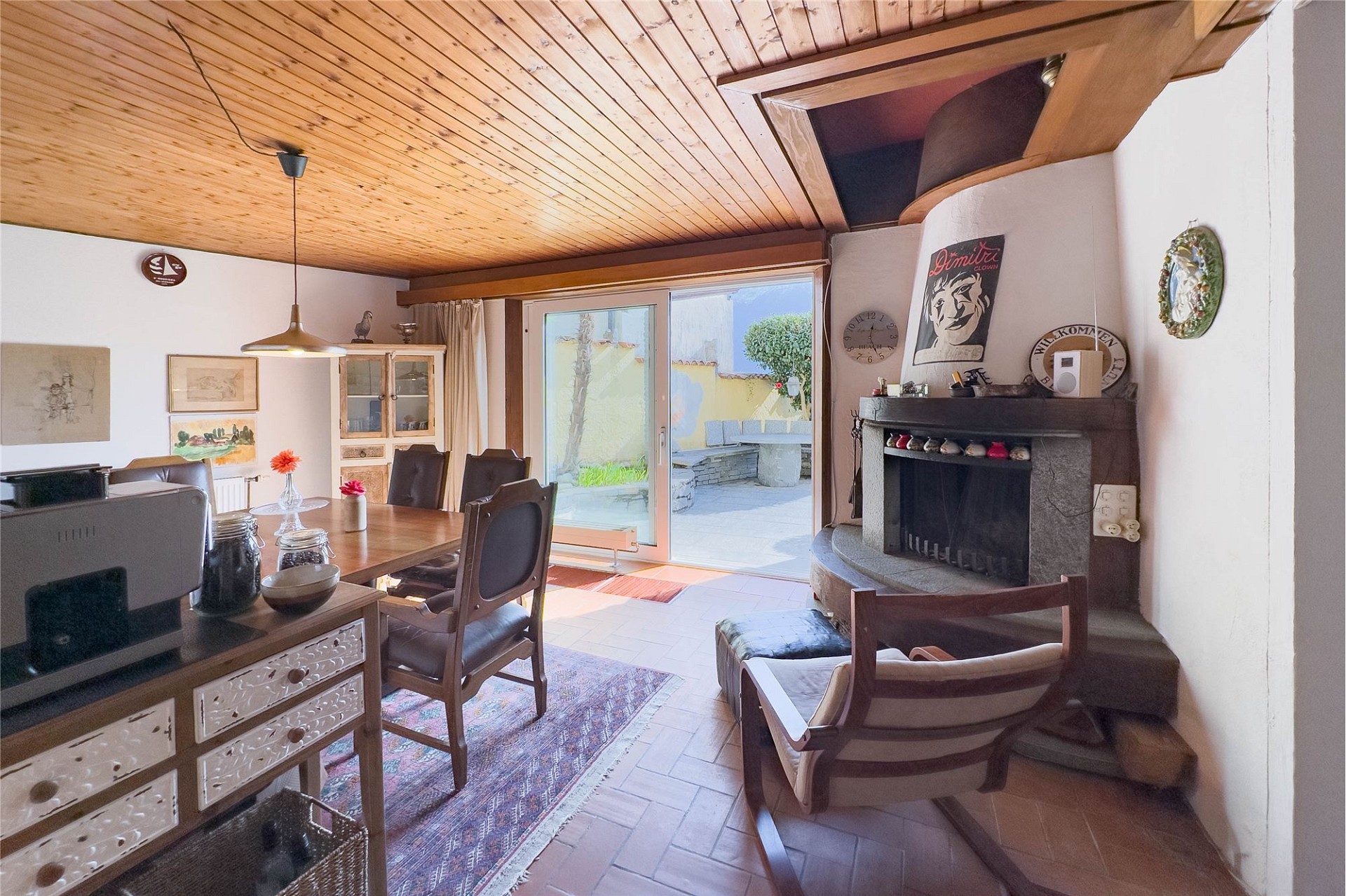 Gemütlicher Wohn- und Essbereich mit Kamin und Terrassenzugang