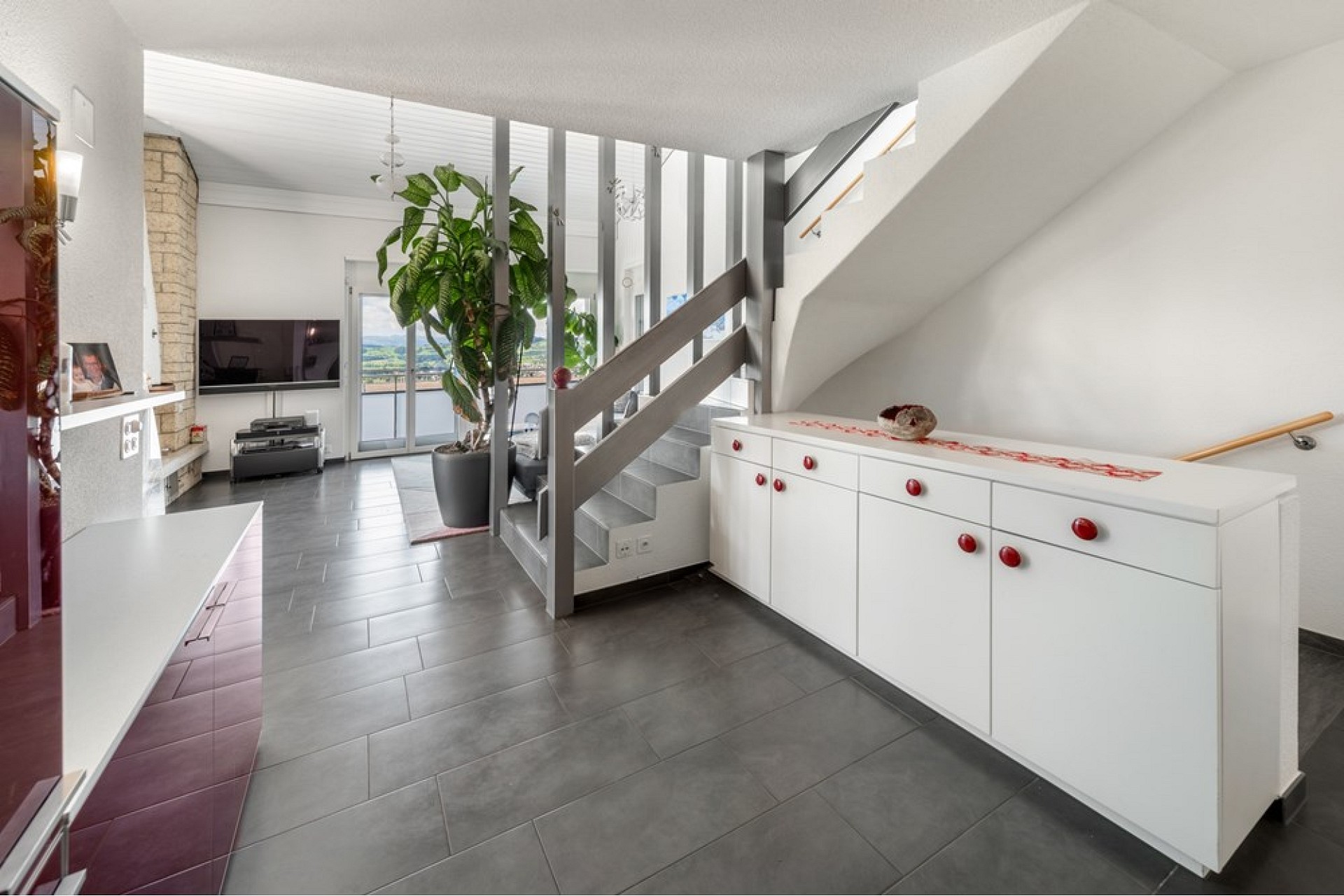 Heller Wohnbereich mit Treppe und großer Fensterfront