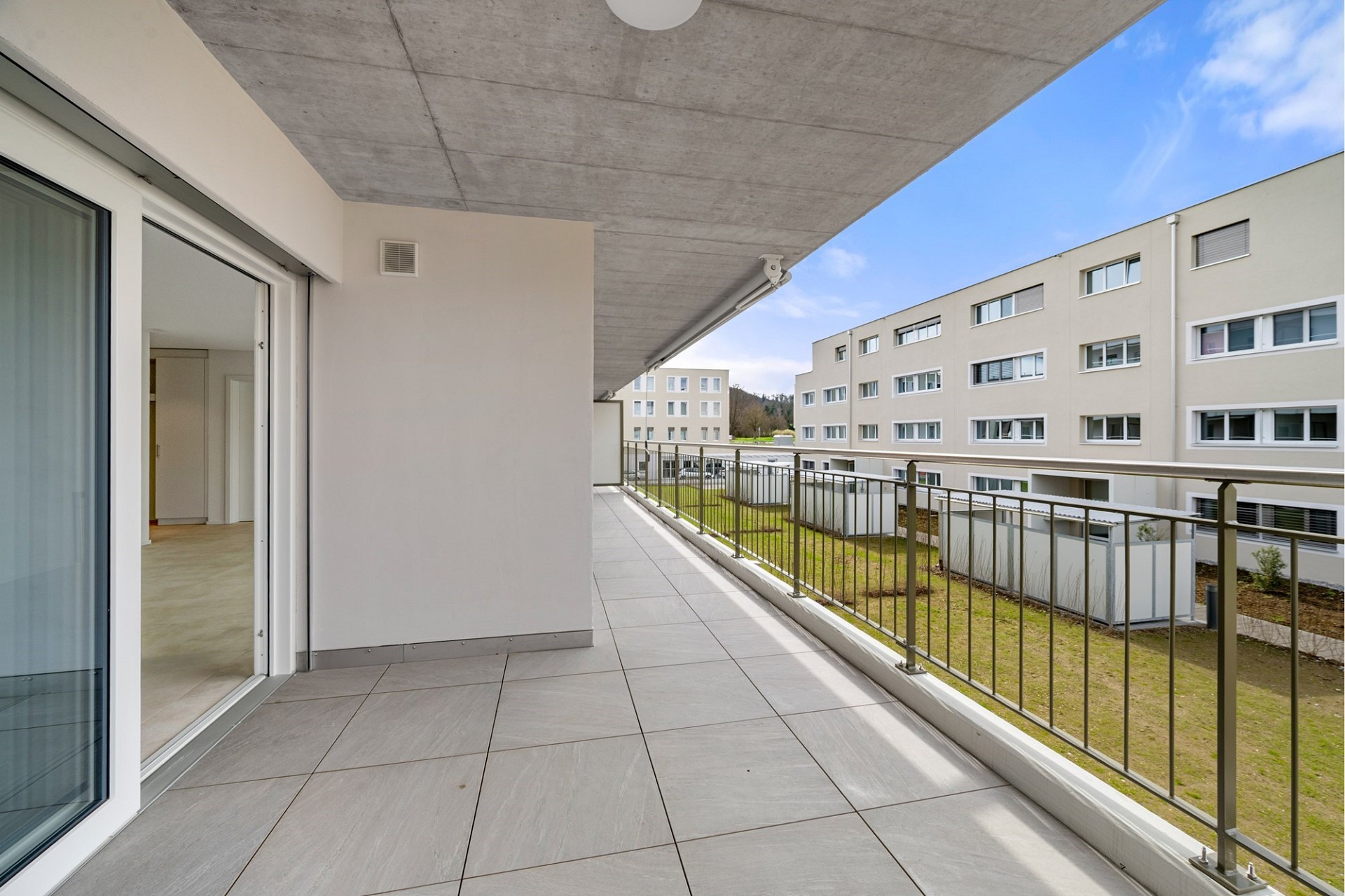 Großer Balkon mit Blick auf Wohnanlage
