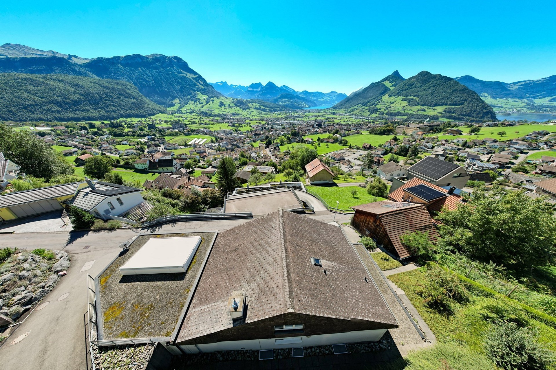 Luftaufnahme eines Hauses mit Alpenpanorama