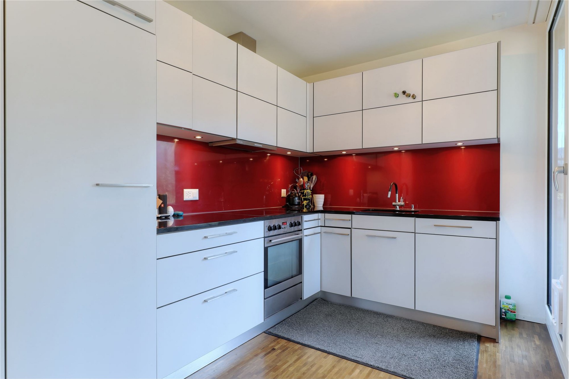 Moderne Einbauküche mit roter Rückwand