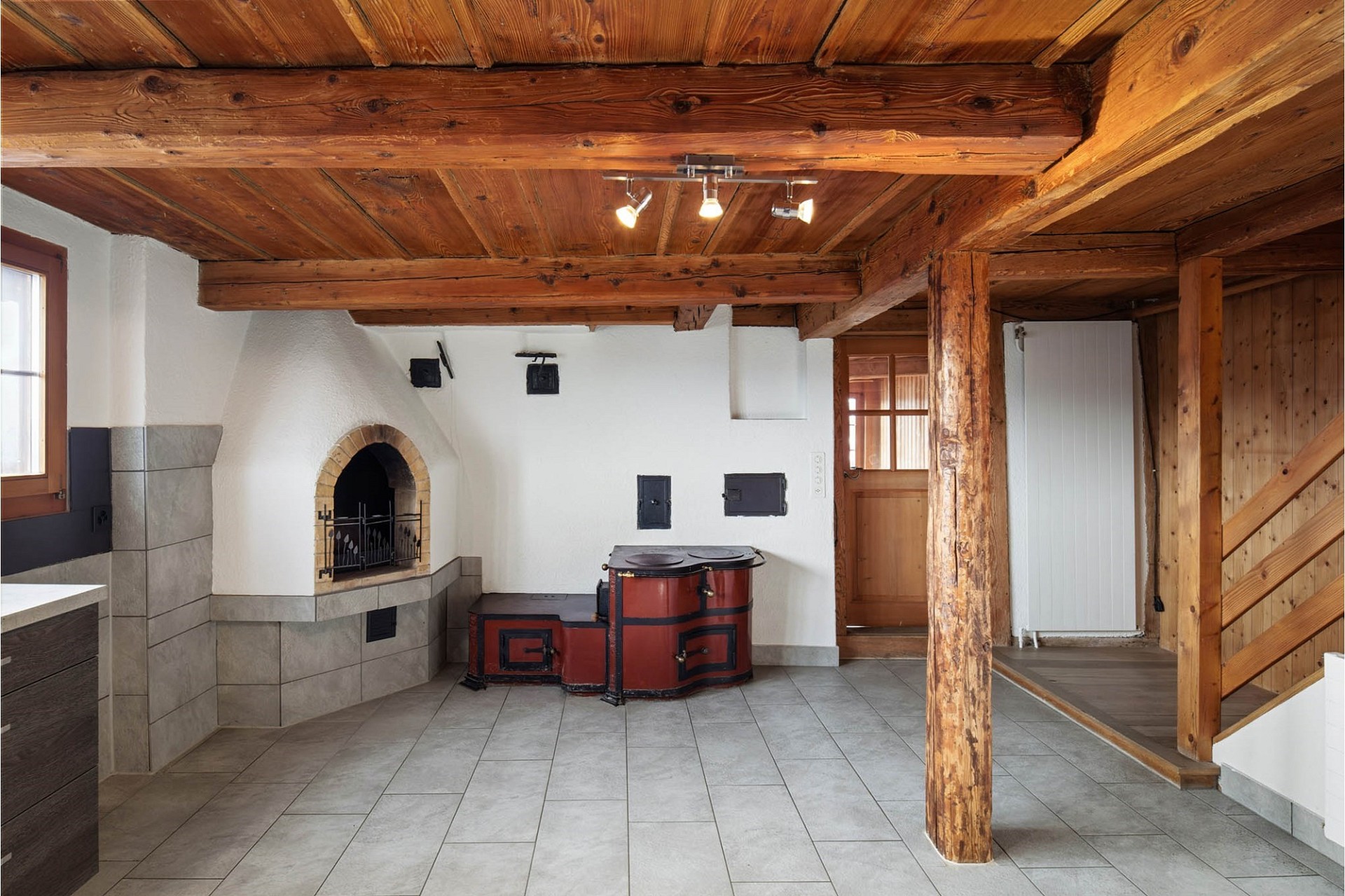 Rustikaler Wohnraum mit Holzdecke und Kamin