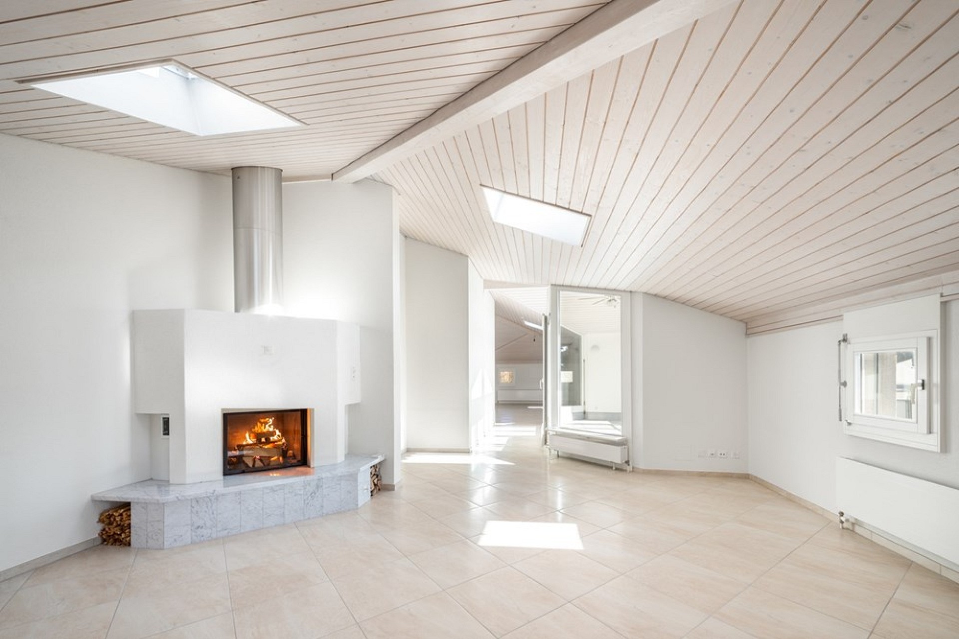 Heller Wohnraum mit Kamin und Dachschrägen